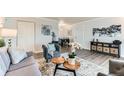 Comfortable living room with neutral colors, wood-look floors, and modern decor at 10211 Ura Ln # 1-308, Thornton, CO 80260
