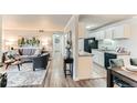 Open-concept layout, the kitchen seamlessly flows into the living room, perfect for modern living at 10211 Ura Ln # 1-308, Thornton, CO 80260