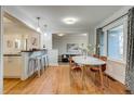 Bright dining space flowing into the living room with hardwood floors and modern decor at 2281 Florence St, Aurora, CO 80010