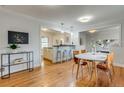 Inviting dining area with hardwood floors and a stylish kitchen view at 2281 Florence St, Aurora, CO 80010