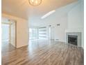 Bright living room with vaulted ceilings, fireplace, and sliding doors to balcony at 10303 E Peakview Ave # G203, Englewood, CO 80111