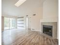 Spacious living room features skylight, floating shelves, and a cozy fireplace at 10303 E Peakview Ave # G203, Englewood, CO 80111
