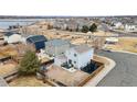 Aerial view of a neighborhood featuring well-maintained houses with fenced yards and community parks at 1212 Magpie Ave, Brighton, CO 80601