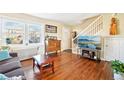 Bright living room featuring hardwood floors, large windows, and a staircase at 2805 Jasmine St, Denver, CO 80207