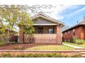Charming brick home with a cozy front porch and manicured landscaping at 3361 W 36Th Ave, Denver, CO 80211