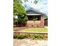 Charming brick home with manicured lawn and inviting front porch, perfect for relaxing at 3361 W 36Th Ave, Denver, CO 80211