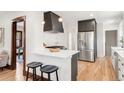 The modern kitchen features stainless steel appliances, stylish bar seating, and great storage at 3361 W 36Th Ave, Denver, CO 80211