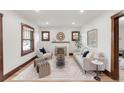 Sun-filled living room offers wood trim windows, decorative fireplace, and a stylish rug at 3361 W 36Th Ave, Denver, CO 80211