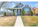Charming two-story home with a cozy front porch, manicured lawn, and well-maintained landscaping at 5140 Mt Pawnee Ave, Frederick, CO 80504