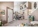 Open-concept dining area with stylish chandelier, staircase view and access to the kitchen at 4301 S Pierce St # 4D, Littleton, CO 80123