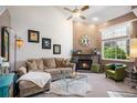 Bright living room features a fireplace, large window, and plush seating, perfect for relaxing or entertaining at 4301 S Pierce St # 4D, Littleton, CO 80123