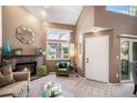 Cozy living room featuring a brick fireplace, large window, and neutral decor for comfortable living at 4301 S Pierce St # 4D, Littleton, CO 80123