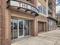Close-up of the building entrance at 1441 Central Street, with garage entry to the right at 1441 Central St # 203, Denver, CO 80211