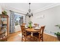 Dining room featuring a round table, wood floors, and a chandelier at 29145 E 160Th Ct, Brighton, CO 80603