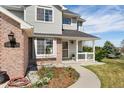 Inviting front porch with well-manicured landscaping and brick accents on a beautiful home at 29145 E 160Th Ct, Brighton, CO 80603