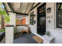 Inviting front porch featuring a cozy chair, stylish lighting, and black accents at 451 S Franklin St, Denver, CO 80209