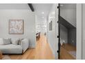 Hallway view featuring hardwood floors, neutral paint, and an open layout at 451 S Franklin St, Denver, CO 80209