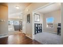 Inviting home foyer featuring gleaming hardwood floors and an entryway leading to the living spaces at 19703 Serenity Springs Pt, Monument, CO 80132