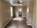 Inviting living room with hardwood floors, fresh paint, lots of natural light, and a modern ceiling fan at 4875 Lowell Blvd, Denver, CO 80221