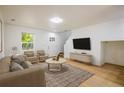 Inviting living room featuring neutral tones, hardwood floors, comfortable seating, and natural light at 5225 E 100Th Dr, Thornton, CO 80229