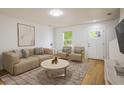 Cozy living room with hardwood floors, neutral decor, comfortable seating, and a welcoming ambiance at 5225 E 100Th Dr, Thornton, CO 80229