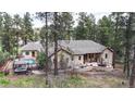 Private backyard with a pool, hot tub, and patio area for outdoor entertaining at 4456 Mohawk Dr, Larkspur, CO 80118