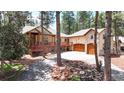 Gorgeous home with stone details, a wrap-around deck, and mature trees at 4456 Mohawk Dr, Larkspur, CO 80118
