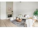 Bright living room with fireplace, light wood floors, and neutral decor at 1011 Pierce St # 5, Lakewood, CO 80214