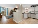 Open-concept living room and kitchen with updated cabinets and tile flooring and lots of natural light at 601 W 11Th Ave # 409, Denver, CO 80204