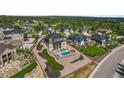 Stunning aerial view of a home with a pool, seating area, and beautifully landscaped backyard at 5625 Heritage Oak Dr, Parker, CO 80134