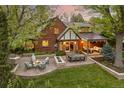 Expansive backyard with a dining table, patio seating, a built-in grill, and a cozy covered patio with fire pit at 6248 S Coventry Ln, Littleton, CO 80123
