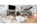 Cozy living room featuring a fireplace, contemporary decor, and hardwood floors at 872 S Vine St, Denver, CO 80209