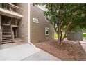 Side view of condo building with exterior staircase and building number display at 4896 S Dudley St # 8-11, Littleton, CO 80123