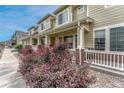 Beautiful exterior view of townhomes featuring manicured landscaping, inviting front porches, and a friendly neighborhood setting at 16051 E Geddes Dr # 66, Aurora, CO 80016