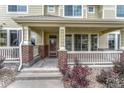 Inviting front porch with brick accents, steps, and a charming entryway to a lovely townhome at 16051 E Geddes Dr # 66, Aurora, CO 80016