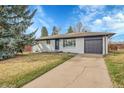 Charming single-story home featuring a well-manicured lawn and an attached garage with a driveway at 365 W Peakview Ave, Littleton, CO 80120