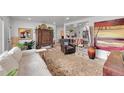 Open-concept living area with hardwood floors, plush seating, and stylish decor leading into the dining area at 365 W Peakview Ave, Littleton, CO 80120