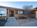 Inviting front entrance with brick accents and wooden details at 10353 N Chatfield Dr, Littleton, CO 80125