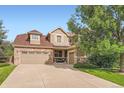 Charming home with stone accents, a three-car garage, and a welcoming front porch at 15056 Fillmore Way, Thornton, CO 80602