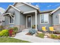 Inviting front entrance with stone accents and colorful landscaping at 6845 W Evans Ave, Denver, CO 80227