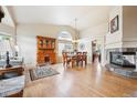 Spacious living room featuring a fireplace, hardwood floors, and ample natural light at 3305 White Oak Ln, Highlands Ranch, CO 80129