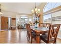 Bright living room with hardwood floors, large windows, and a view into another living space at 3305 White Oak Ln, Highlands Ranch, CO 80129