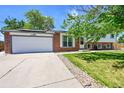 Exterior view showcasing the attached garage and brick accents on this well-maintained home at 11000 Eudora Cir, Thornton, CO 80233