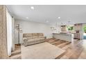 Open-concept living room featuring modern floors and a cozy seating area connected to kitchen at 11000 Eudora Cir, Thornton, CO 80233