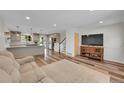 Spacious living room with view to the kitchen featuring wood floors and lots of natural light at 11000 Eudora Cir, Thornton, CO 80233