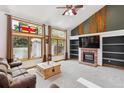 Bright living room with large windows, fireplace, and vaulted ceilings perfect for gatherings at 5282 Devon Ave, Castle Rock, CO 80104