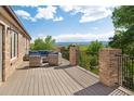 Relaxing outdoor seating area on a spacious deck with scenic views of mountains and trees at 2595 S Harlan Ct, Lakewood, CO 80227