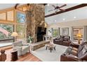 Spacious living room with a stone fireplace and leather furniture at 9724 E Villasur Ct, Parker, CO 80134