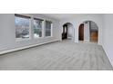 Large living room featuring a light, neutral paint palette, modern carpet and entry to front door at 12341 E Cedar Cir, Aurora, CO 80012