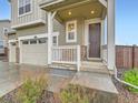 Inviting front entrance with white porch and brown door provides curb appeal and a sense of arrival at 14687 Eudora St, Thornton, CO 80602